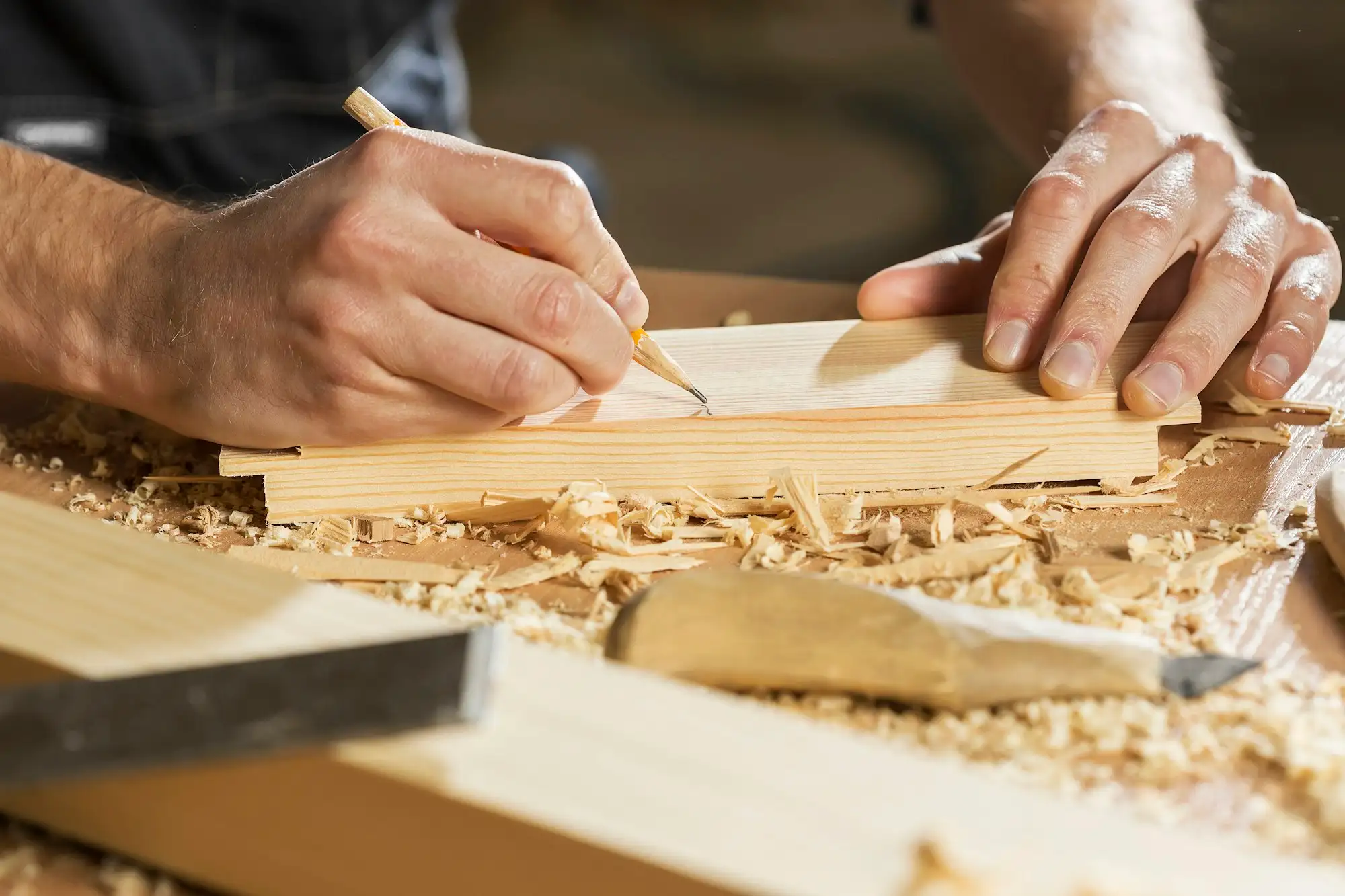 Joiner marking timber in a workshop before cutting