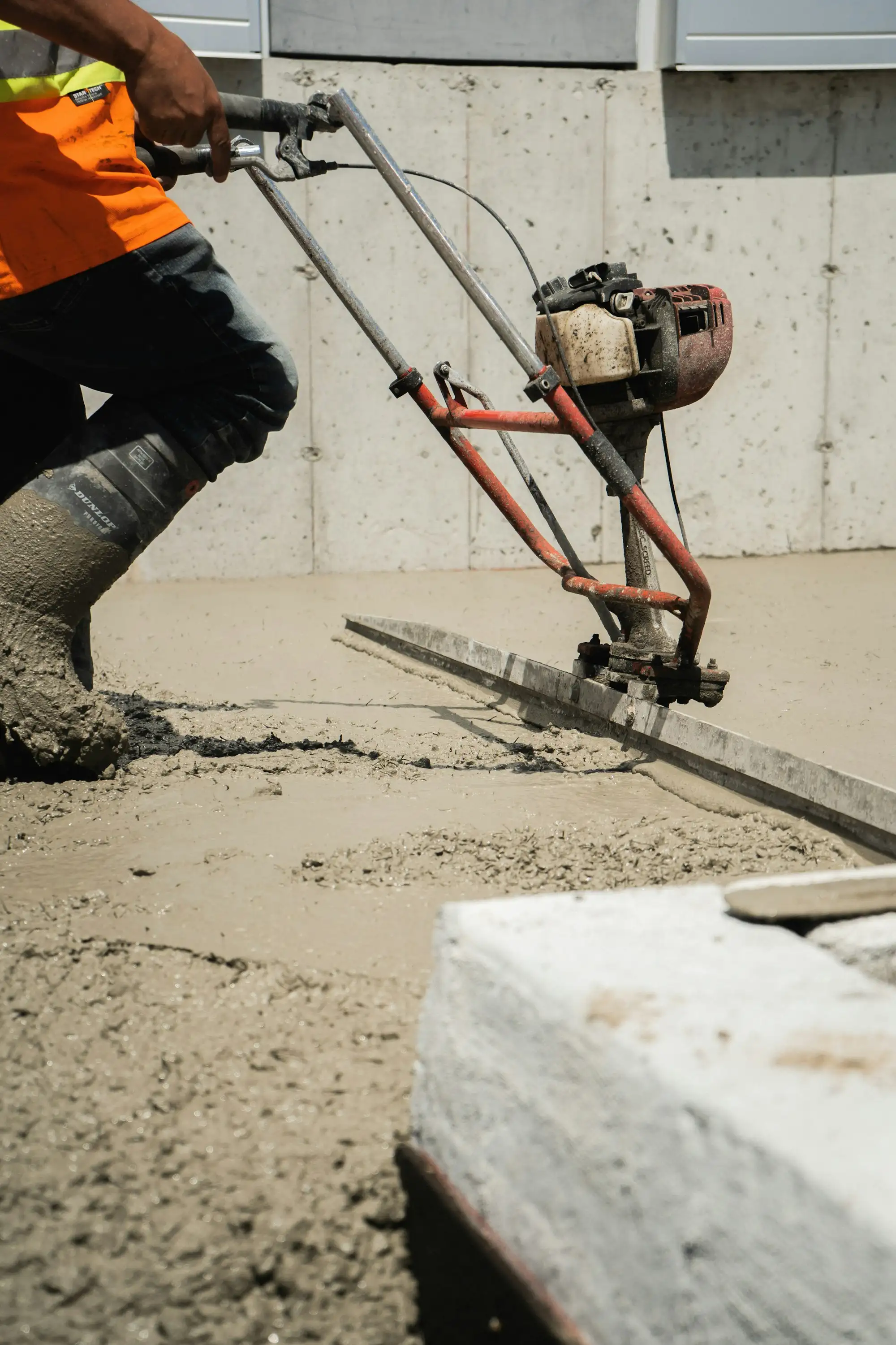 Concrete being poured into formwork for a slab on a residential site