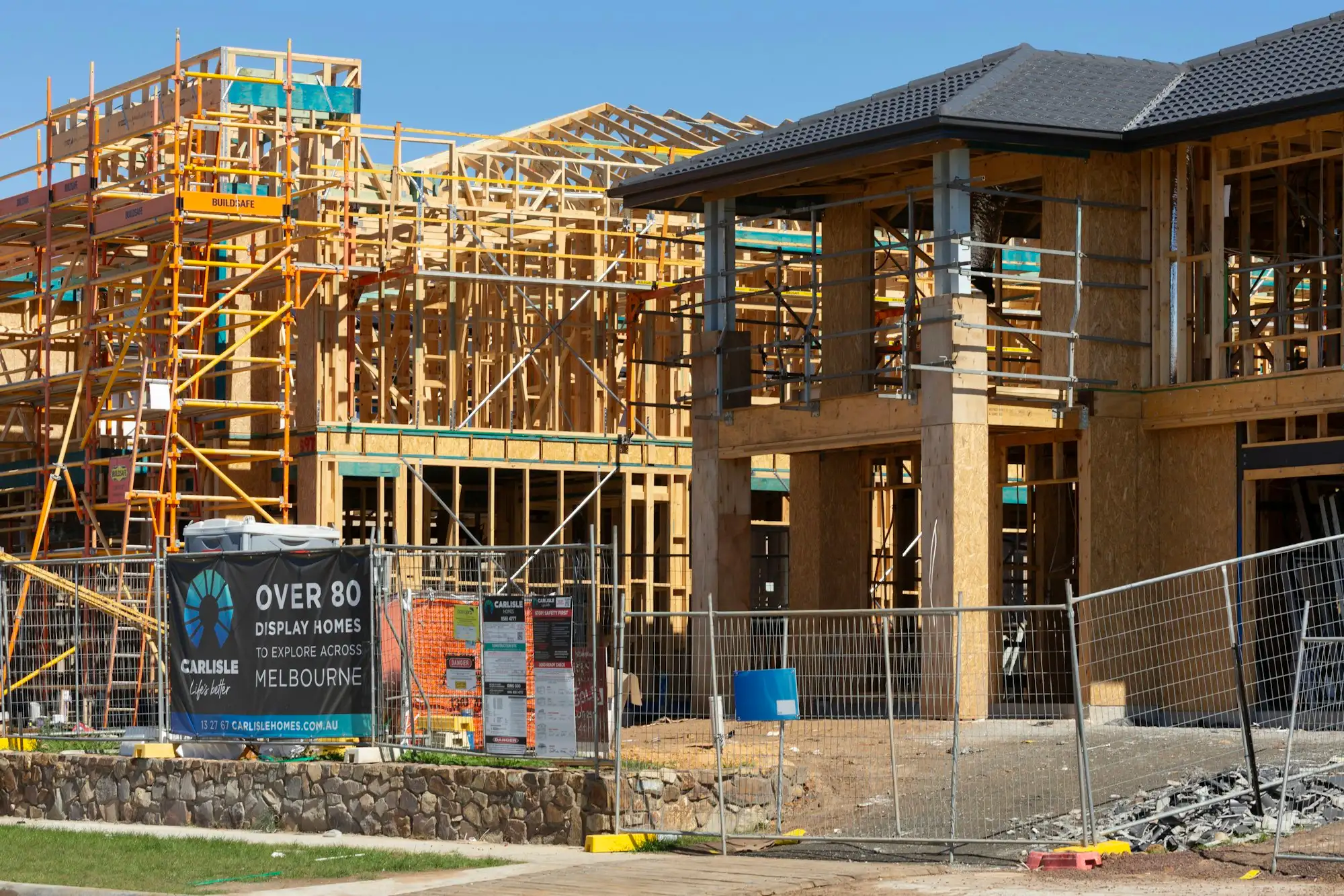 Homes at different build stages in a new Australian housing estate