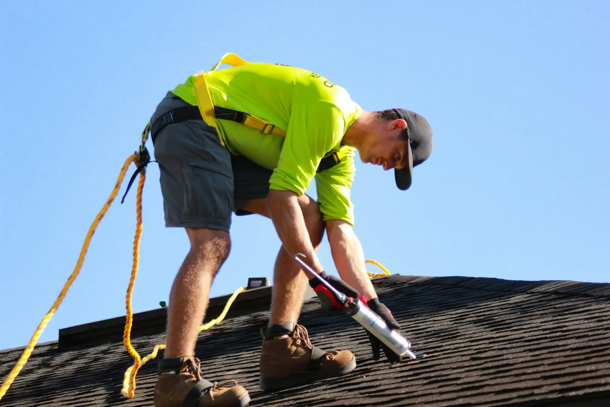 Roof plumber working on a metal roof of a residential home